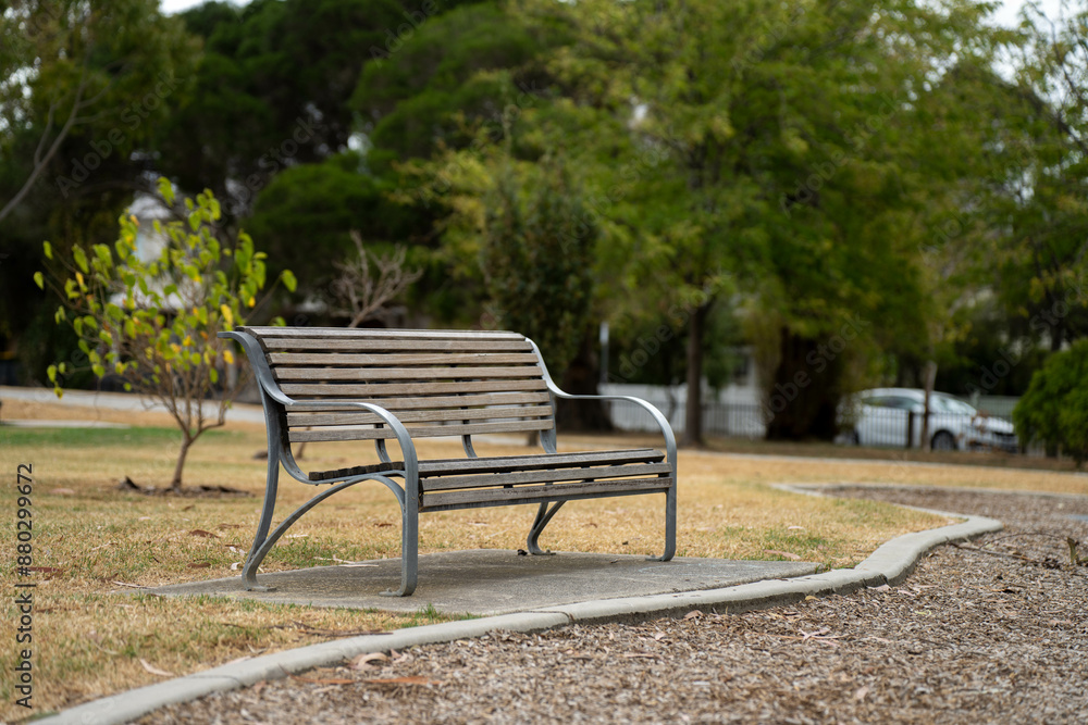 park benches and seats in a park around a football sports oval on a sunny spring day, with people playing sport to stay fit on a sunny melbourne day park benches and seats in a park around a football sports oval on a sunny spring day, with people playing sport to stay fit on a sunny melbourne day