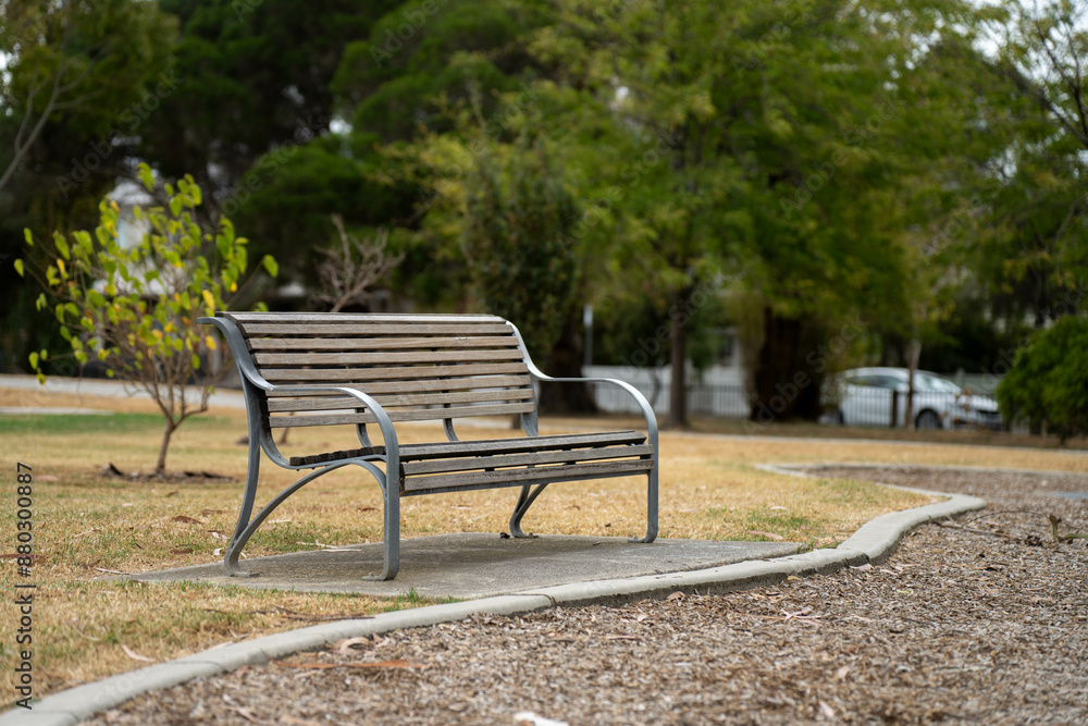 park benches and seats in a park around a football sports oval on a sunny spring day, with people playing sport to stay fit on a sunny melbourne day park benches and seats in a park around a football sports oval on a sunny spring day, with people playing sport to stay fit on a sunny melbourne day