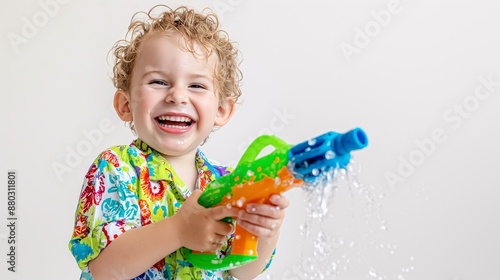 A happy child with a large water gun. photo