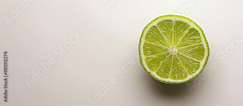 A close-up selective shot of half a green lime on a light background with copy space image.