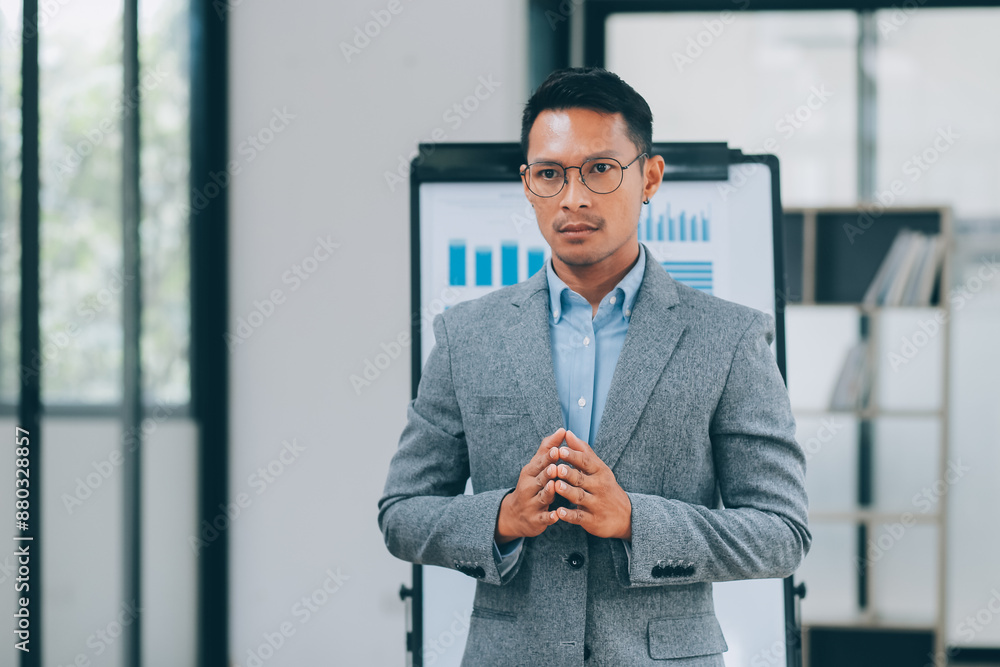 Fototapeta premium Young businessman giving presentation to his colleagues