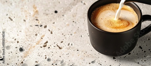 Pouring steamed milk into a...