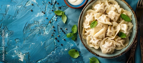 Top view of traditional Russian dumplings and ravioli on a blue background with copy space image available photo