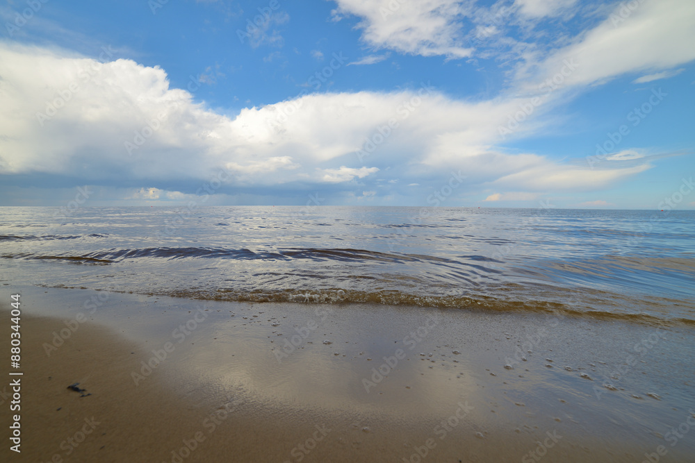 Picturesque beach with blue sky and fluffy white clouds