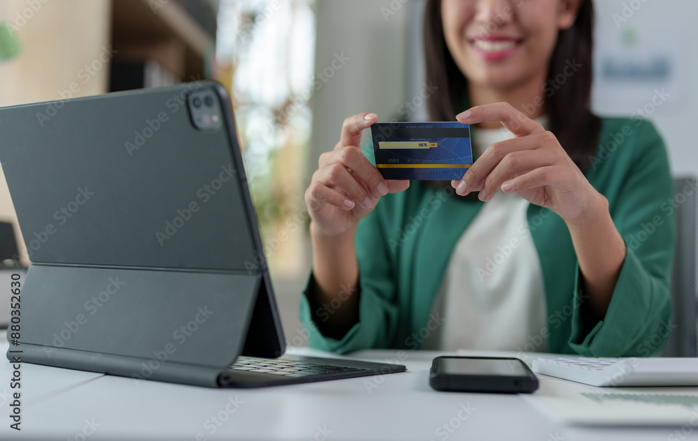 Online payment Businesswoman's hands holding a credit card and using a laptop computer for online shopping Calculating financial statements, banks, financial transactions. Online payment Businesswoman's hands holding a credit card and using a laptop computer for online shopping Calculating financial statements, banks, financial transactions.