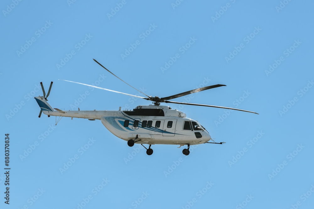 Big offshore civil transport helicopter is flying rotary-wing aircraft fireproof steel cowlings blue sky Big offshore civil transport helicopter is flying rotary-wing aircraft fireproof steel cowlings blue sky