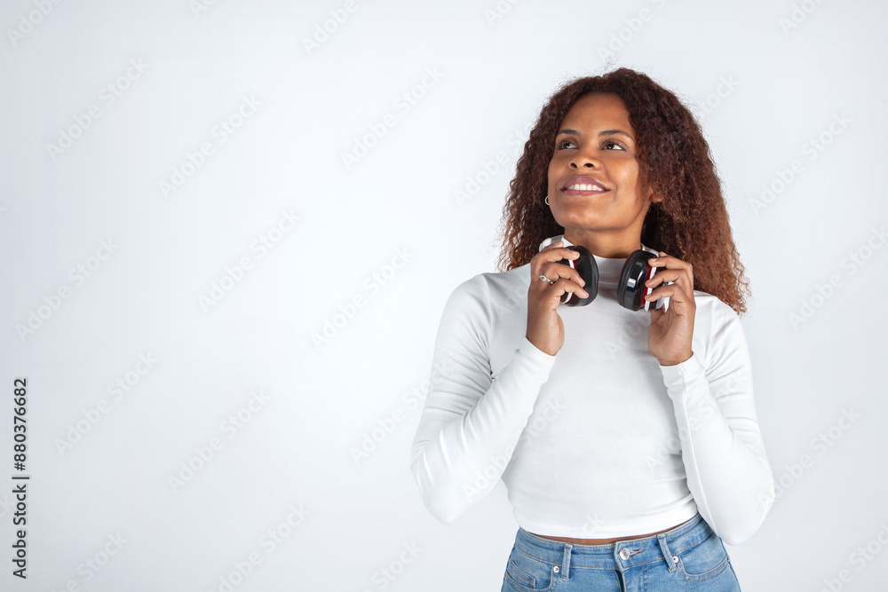 Mujer con auriculares, Mujer negra mirando al cielo soñando o pensando, Estilo de vida, Disfrutar de la música, publicidad Mujer con auriculares, Mujer negra mirando al cielo soñando o pensando, Estilo de vida, Disfrutar de la música, publicidad