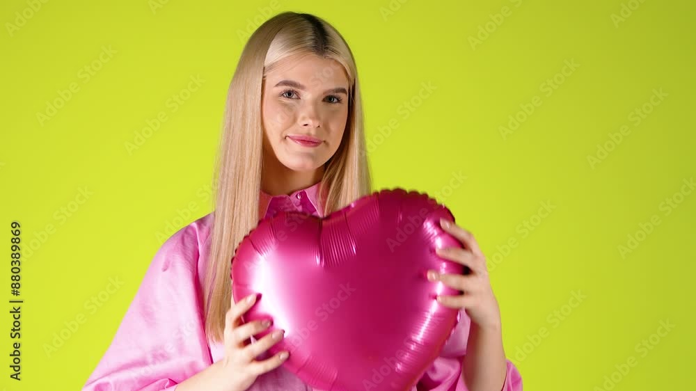 Pretty Blonde Woman Holding Hugging Heart Shaped Purple Balloon, Valentine's Mood With Colorful Background, Studio Shot Pretty Blonde Woman Holding Hugging Heart Shaped Purple Balloon, Valentine's Mood With Colorful Background, Studio Shot