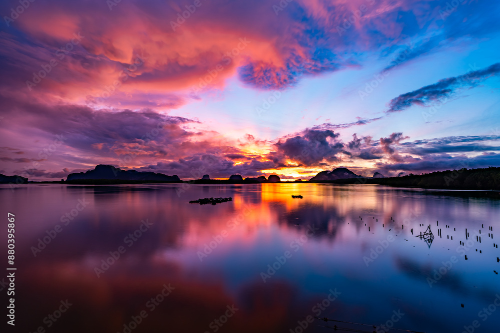 Obraz premium Landscape Long exposure of majestic clouds in the sky sunset or sunrise over sea with reflection in the tropical sea.Beautiful cloudscape scenery.Amazing light of nature Landscape nature background