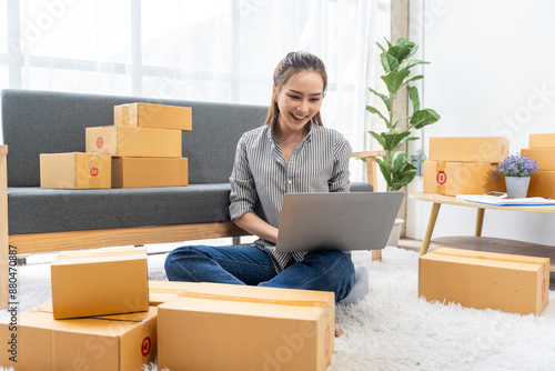 Portrait of Starting small businesses SME owners female entrepreneurs working on receipt box and check online orders to prepare to pack the boxes, sell to customers, SME business ideas online.