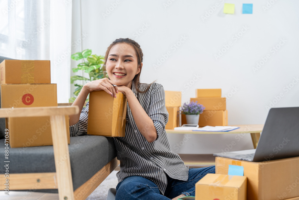 asian young woman owner packing product box prepare to the package for delivery to the customer on sofa at home office asian Entrepreneur SME business asian young woman owner packing product box prepare to the package for delivery to the customer on sofa at home office asian Entrepreneur SME business