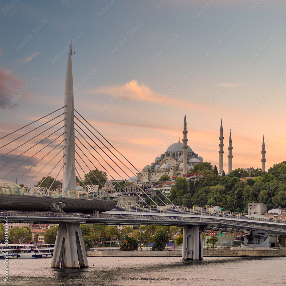 Sunset shot of Golden Horn Metro Bridge, or Halic Bridge, overlapping Suleymaniye Mosque, Istanbul, Turkey Sunset shot of Golden Horn Metro Bridge, or Halic Bridge, overlapping Suleymaniye Mosque, Istanbul, Turkey