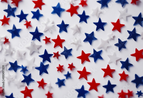 A patriotic array of scattered red white and blue stars on a clean white backdrop