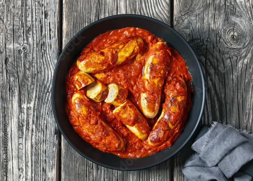 German Currywurst, pork sausages in a curry sauce photo