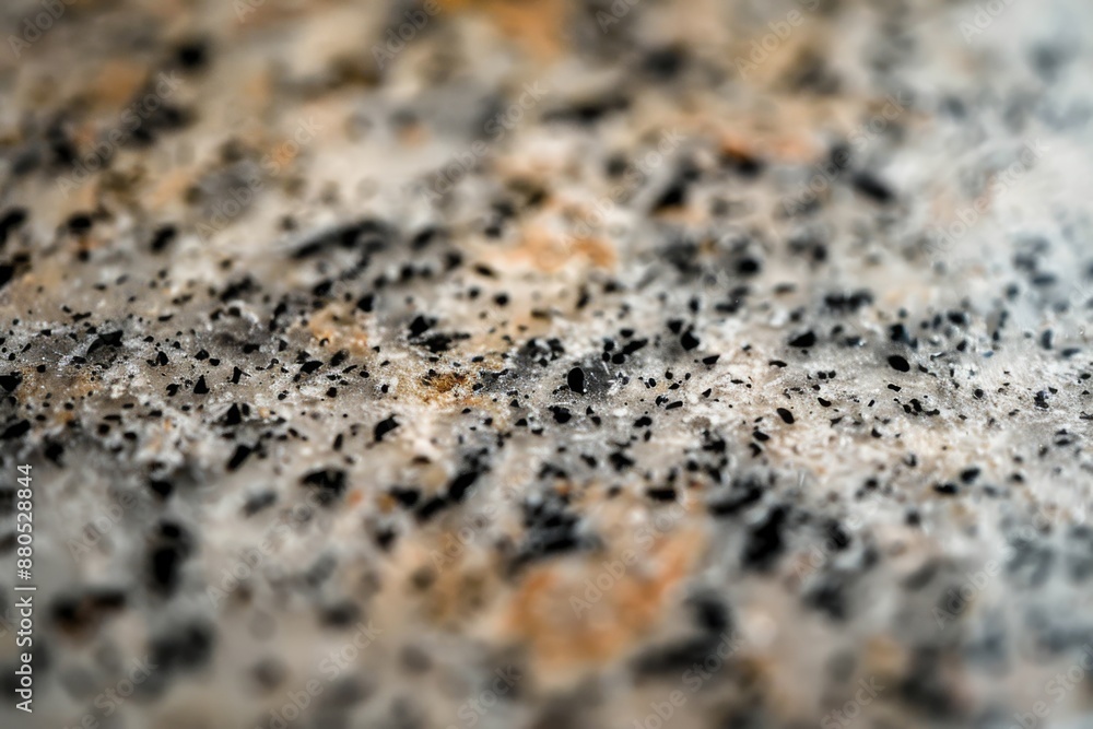 A close-up view of a granite countertop showcasing its polished, speckled surface. The intricate patterns and colors of the granite are highlighted in this detailed shot. A close-up view of a granite countertop showcasing its polished, speckled surface. The intricate patterns and colors of the granite are highlighted in this detailed shot.