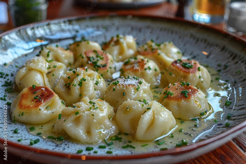 A serving of pelmeni, Russian dumplings filled with meat, topped with melted butter and a sprinkle of chives. A serving of pelmeni, Russian dumplings filled with meat, topped with melted butter and a sprinkle of chives.