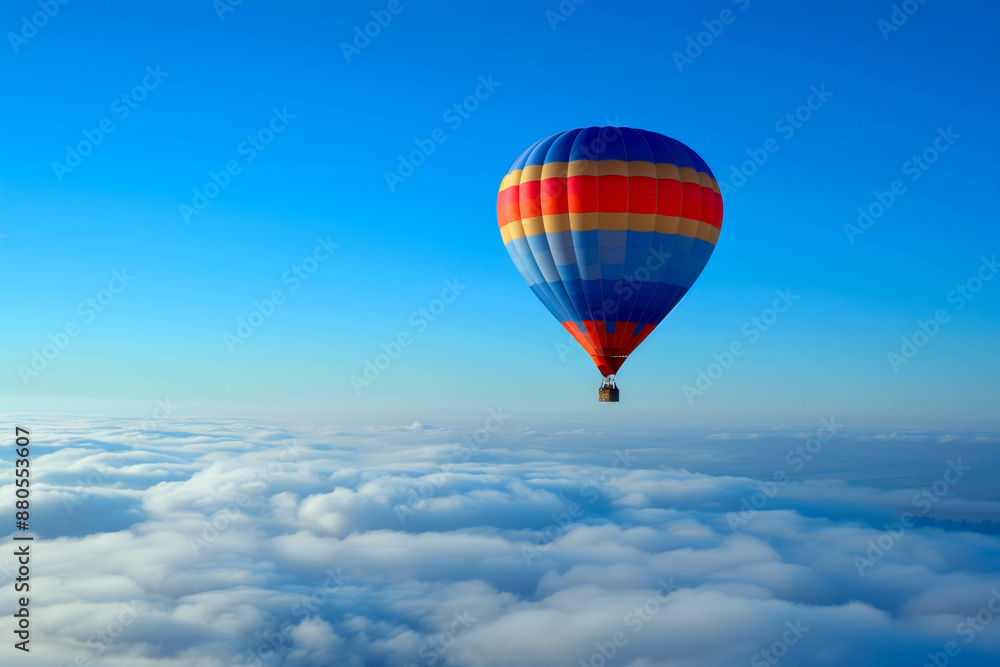 Fototapeta premium A colorful hot air balloon floating high above the clouds
