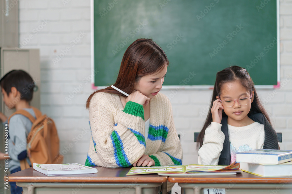 Φωτογραφία young attractive asian woman,teacher helping a kid one by one on the lesson,a pu