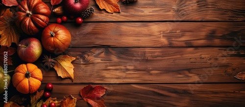 Wooden table background decorated with autumn leaves and fruits creates a scenic copy space image