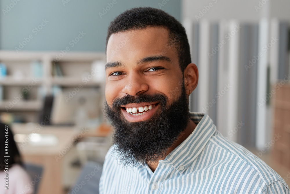 Portrait of African American happy handsome man smiling in modern office, closeup Portrait of African American happy handsome man smiling in modern office, closeup