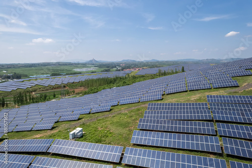 Extensive Solar Farm in Rolling Countryside Under Clear Sky photo