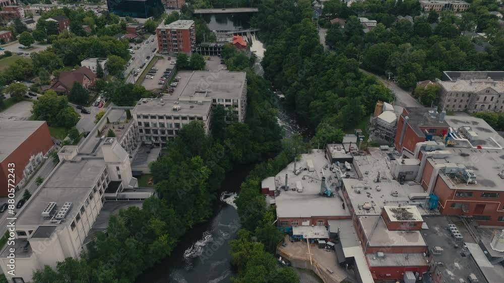 The Magog River Flows Through the City of Sherbrooke in Quebec, Canada - Aerial Drone Shot The Magog River Flows Through the City of Sherbrooke in Quebec, Canada - Aerial Drone Shot