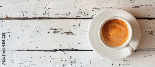 Tasty coffee with milk in a cup on a white wooden table with a copy space image photo