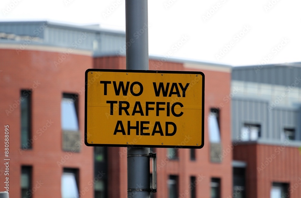 Obraz premium yellow road sign with the inscription two-way traffic ahead