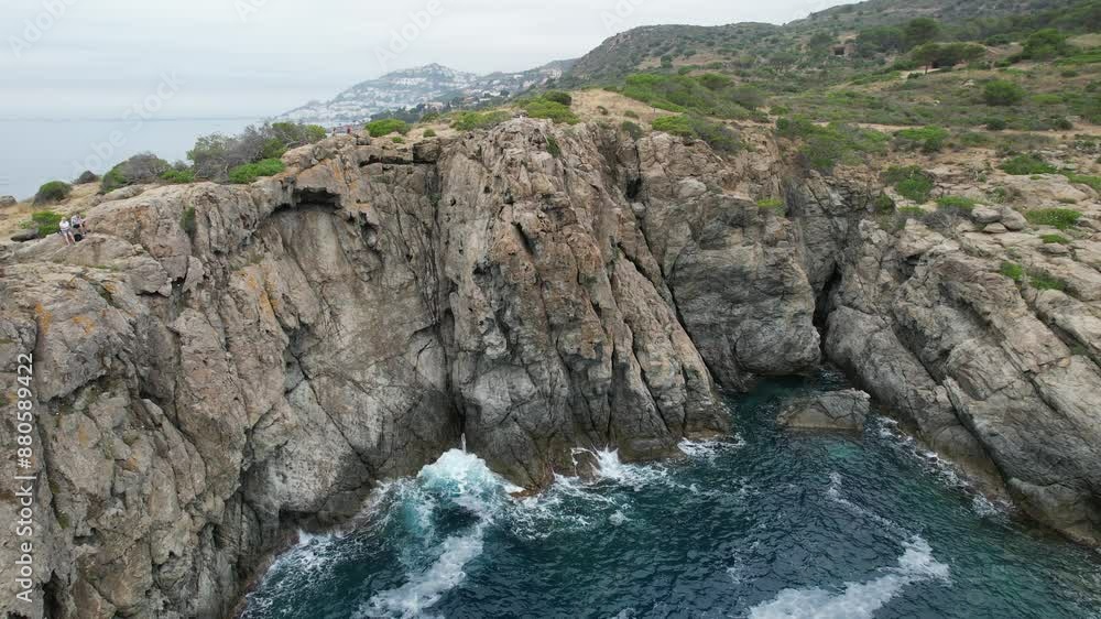 waves crashing on cliff drone flight in Punta Falconera waves crashing on cliff drone flight in Punta Falconera