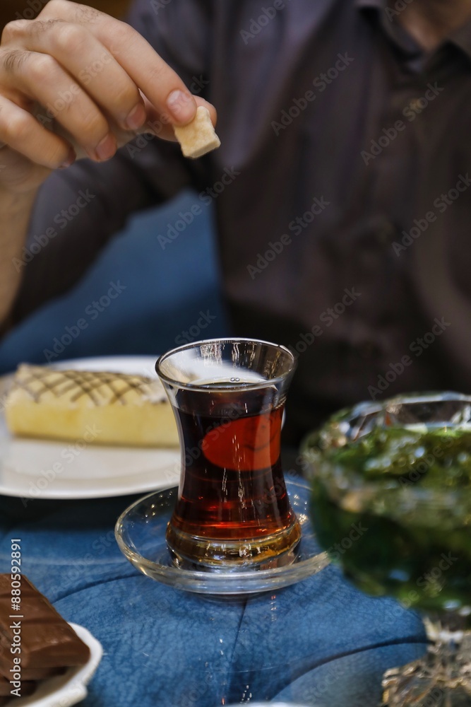 Person Adding Sugar to Turkish Tea Person Adding Sugar to Turkish Tea