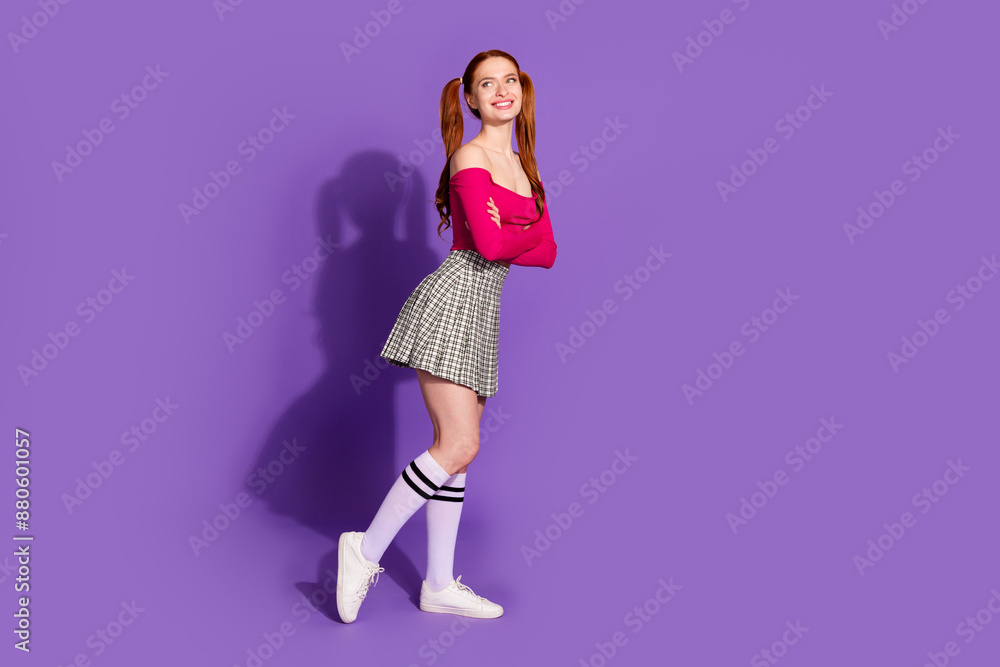 Full length photo of shiny attractive lady dressed off shoulders top arms folded looking empty space isolated violet color background Full length photo of shiny attractive lady dressed off shoulders top arms folded looking empty space isolated violet color background
