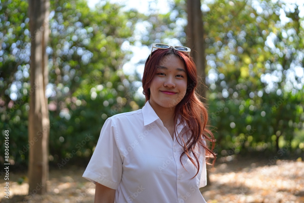 Portrait of asian pretty young woman red hair in white shirt positive smiling cheerful girl Portrait of asian pretty young woman red hair in white shirt positive smiling cheerful girl