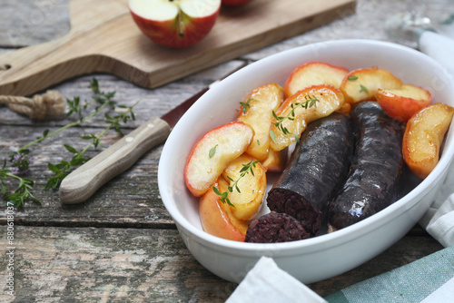 Traditional French cuisine: fried blood sausage and caramelized apples