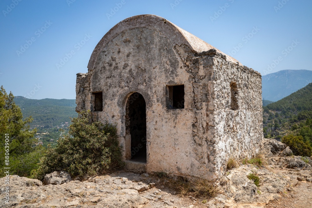 Ancient stone building on a hilltop on a sunny day in Kayakoy neighborhood, Fethiye, Mugla, Turkey Ancient stone building on a hilltop on a sunny day in Kayakoy neighborhood, Fethiye, Mugla, Turkey