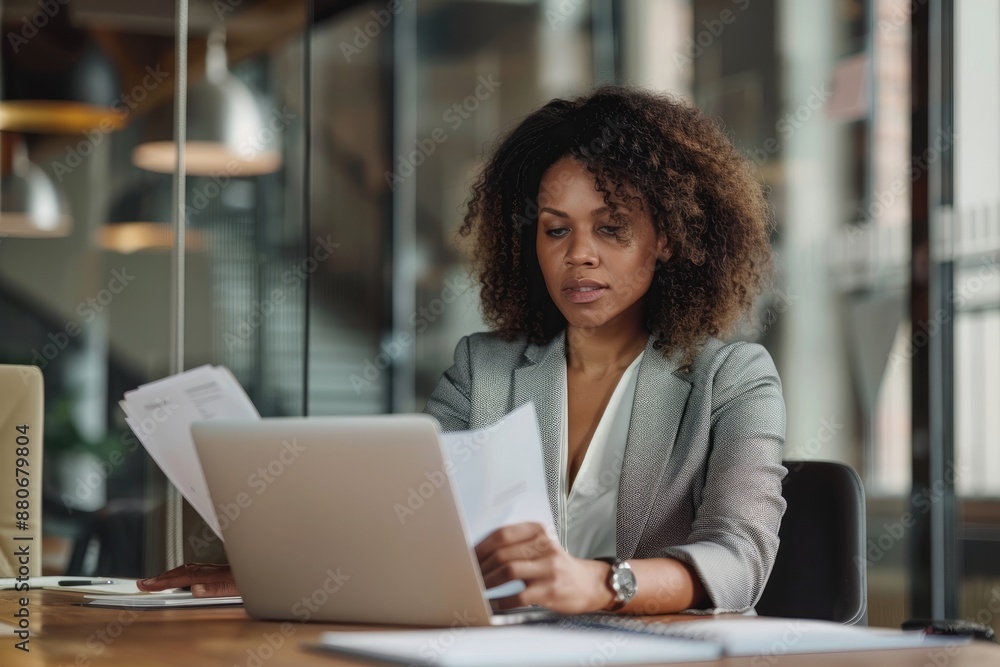 Portrait of businesswoman with laptop writes on a notebook at her office Portrait of businesswoman with laptop writes on a notebook at her office