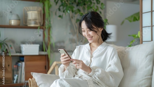 Happy excited young woman relaxing on couch using mobile phone winning in online app game. Young lucky girl feeling winner looking at cellphone, receiving great news or discount offer.