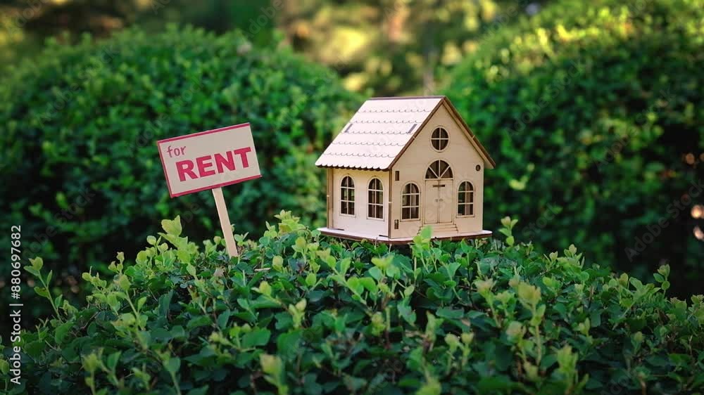 Small a sign rent estate. House for rent. A miniature composition with a toy wooden house. Small a sign rent estate. House for rent. A miniature composition with a toy wooden house.