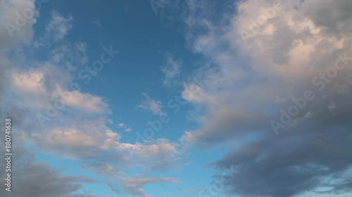 Dark gray storm clouds move quickly in the bright blue sky Time-lapse footage