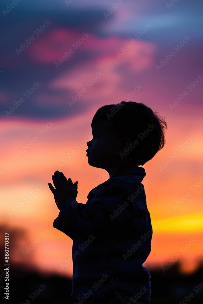 A young child enjoying the beautiful view of a sunset A young child enjoying the beautiful view of a sunset