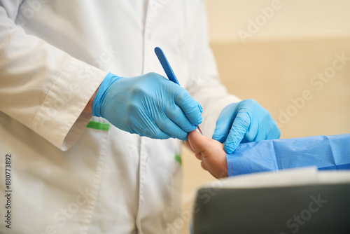 Εκτύπωση καμβά Podiatrist performing toenail surgery on adult person