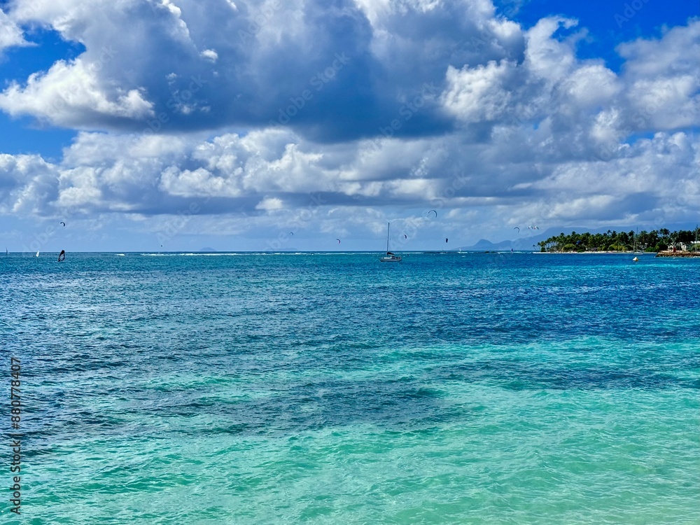 seascape of Guadeloupe in the French West Indies with a view of a lagoon with turquoise waters and a rocky coast with tropical vegetation in the background on a sunny day
seascape of Guadeloupe in the French West Indies with a view of a lagoon with turquoise waters and a rocky coast with tropical vegetation in the background on a sunny day
