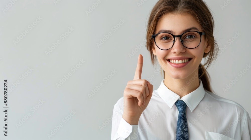 Portrait of a happy young business standing isolated on a light background, showing a hand gesture with his pointing finger to blank space for text or advertisement Portrait of a happy young business standing isolated on a light background, showing a hand gesture with his pointing finger to blank space for text or advertisement