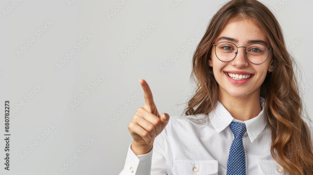 Portrait of a happy young business standing isolated on a light background, showing a hand gesture with his pointing finger to blank space for text or advertisement Portrait of a happy young business standing isolated on a light background, showing a hand gesture with his pointing finger to blank space for text or advertisement