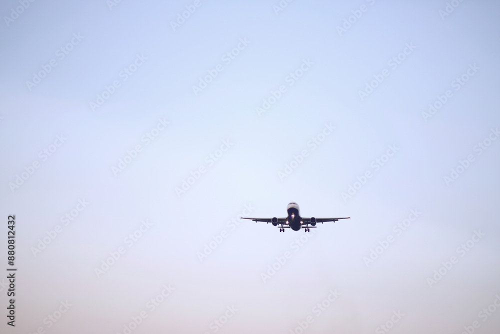 Passenger Airplane Landing Take-Off at Dawn with Clear Sky Background Passenger Airplane Landing Take-Off at Dawn with Clear Sky Background