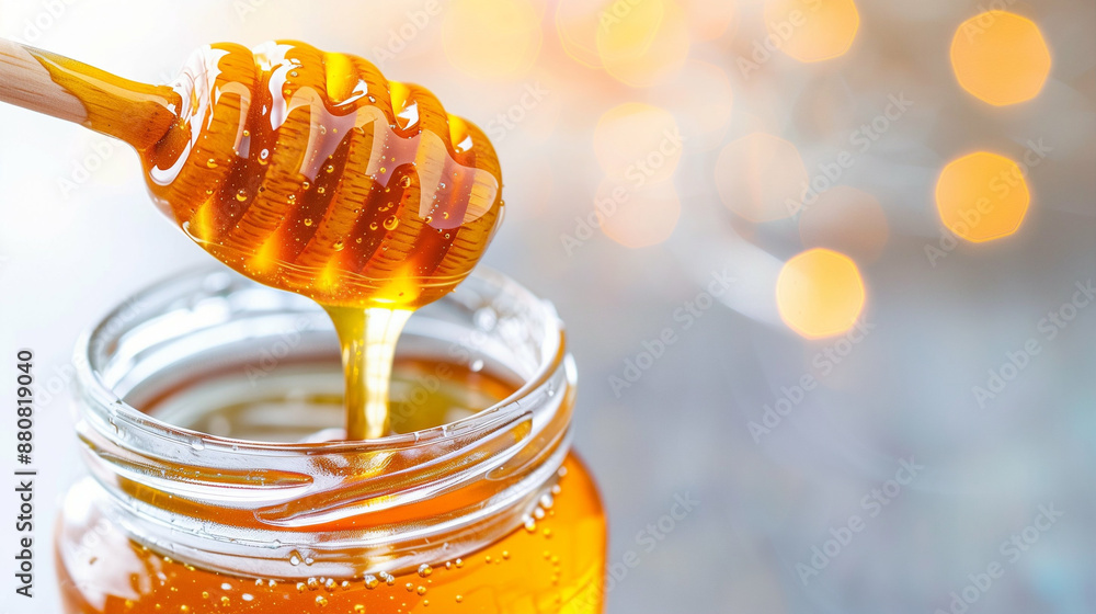 Delicious Golden Honey Dripping from Dipper Into Glass Jar. Pure and Natural Honey Close-Up Delicious Golden Honey Dripping from Dipper Into Glass Jar. Pure and Natural Honey Close-Up