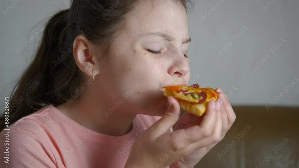 Hungry child eating homemade pizza. A view of hungry little girl hold a piece of pizza and enjoy it taste. Hungry child eating homemade pizza. A view of hungry little girl hold a piece of pizza and enjoy it taste.