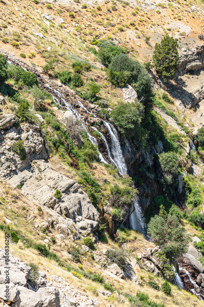 The scenic views of Gömbe Uçarsu Waterfall which fly like a white cloud down the rocks at an altitude of about 50 meters, with a cave underneath, Gömbe, Kaş, Antalya The scenic views of Gömbe Uçarsu Waterfall which fly like a white cloud down the rocks at an altitude of about 50 meters, with a cave underneath, Gömbe, Kaş, Antalya