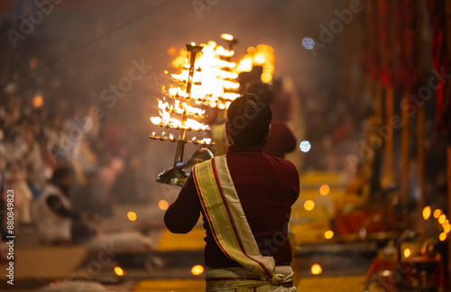 Photography Ganga aarti, Portrait of young priest performing holy river ganges evening aarti at assi ghat in traditional dress with hindu rituals at dashashwamedh ghat