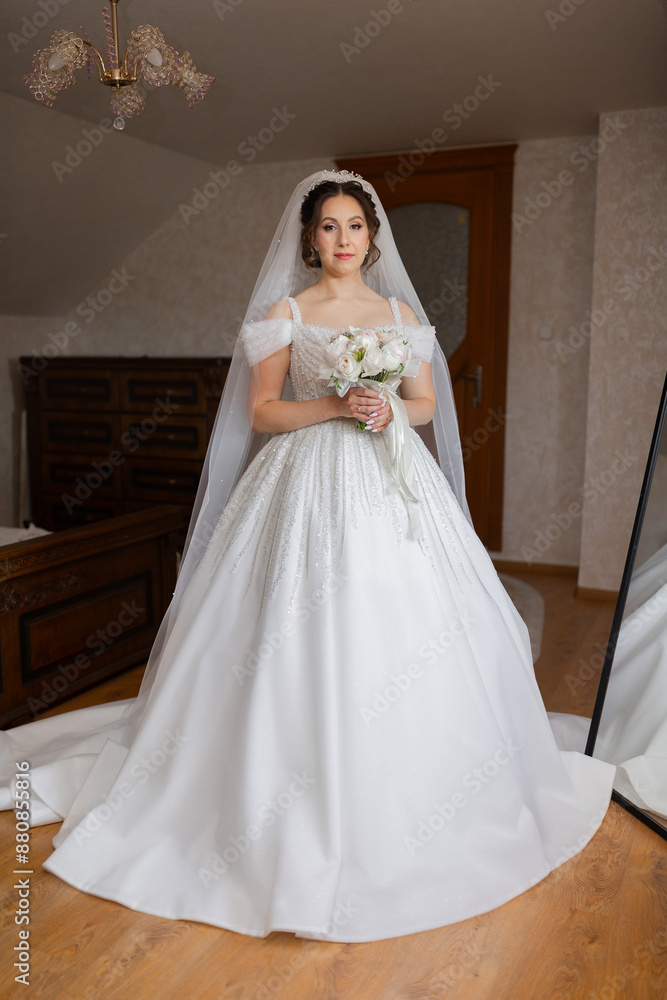 A woman in a white wedding dress is holding a bouquet of flowers. She is standing in front of a mirror, and the room has a warm, inviting atmosphere A woman in a white wedding dress is holding a bouquet of flowers. She is standing in front of a mirror, and the room has a warm, inviting atmosphere