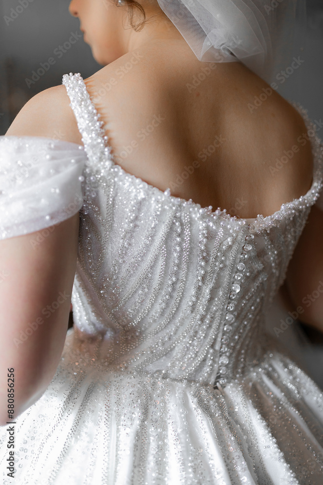 A woman is wearing a white dress with a lot of sparkles on it A woman is wearing a white dress with a lot of sparkles on it